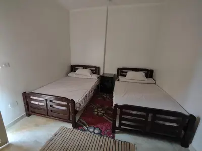 a room with two beds and a rug at شقة الغردقة in Hurghada
