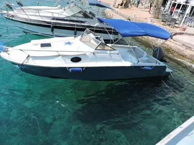 two boats are docked in the water next to a dock at aladdin-travels-egy in Hurghada