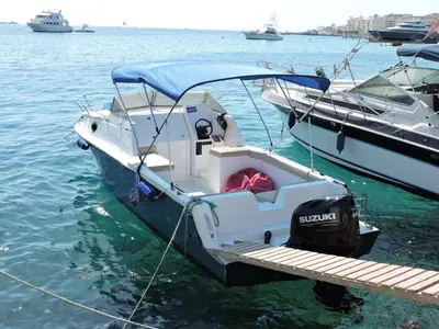 a small boat tied to a dock in the water at aladdin-travels-egy in Hurghada