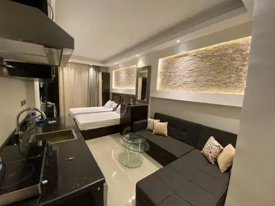 a living room with a couch and a table in it at Cecelia Resort Hurghada H11 in Hurghada
