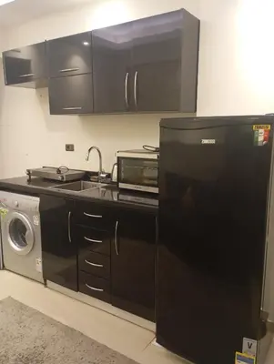a kitchen with a sink and a microwave at Cecelia Resort Hurghada H11 in Hurghada