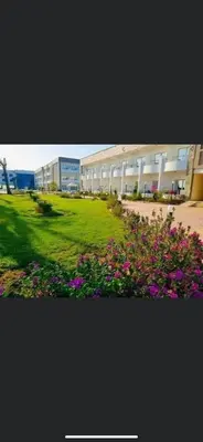 a building with flowers in front of a building at Cecelia Resort Hurghada H11 in Hurghada