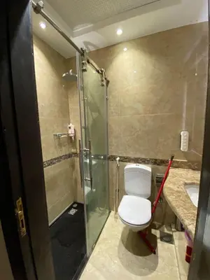 a bathroom with a toilet and a shower and a sink at Cecelia Resort Hurghada H11 in Hurghada