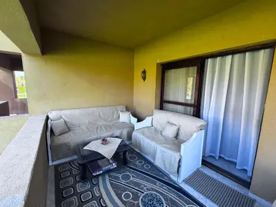 a living room with a couch and a table at Stella Makadi Bay - Pool View Apartment with Beach Access - Holiday Makadi in Hurghada