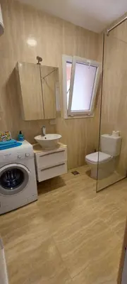 a bathroom with a toilet sink and a washing machine at Stella Makadi Bay - Pool View Apartment with Beach Access - Holiday Makadi in Hurghada