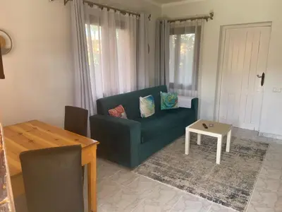 a living room with a blue couch and a table at Stella Makadi Bay - Pool View Apartment with Beach Access - Holiday Makadi in Hurghada