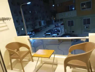 a balcony with chairs and a table and a view of a city at Florenza khamsin Resort Hurghada P109 in Hurghada