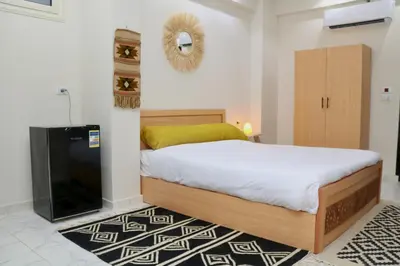 a bedroom with a bed and a flat screen tv at Luxury Arabic Romantic Studio with its own large private Roof Terrace 15 mins from El Gouna in Hurghada