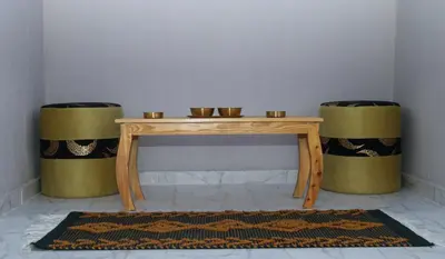 a wooden table with two stools and a table with two drums at Luxury Arabic Romantic Studio with its own large private Roof Terrace 15 mins from El Gouna in Hurghada