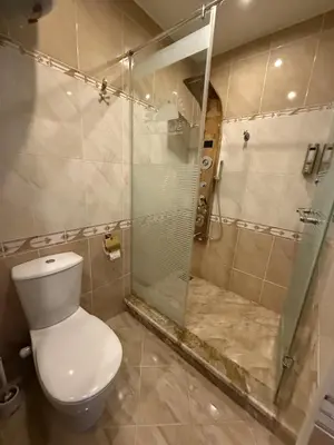 a bathroom with a toilet and a glass shower at studio in Hotel Gravity 5 stelle in Hurghada