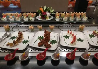 a table topped with plates of food with spoons at studio in Hotel Gravity 5 stelle in Hurghada