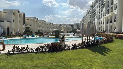 a large building with a large swimming pool next to a building at studio in Hotel Gravity 5 stelle in Hurghada