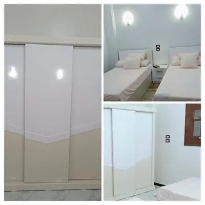 a bedroom with a sliding glass door and a bed at Flower House in Al Aqālitah
