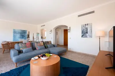 a living room with a blue couch and a table at Luxury Stays in Golf Town Houses in Hurghada