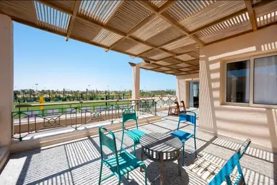 a balcony with chairs and a table and a view at Luxury Stays in Golf Town Houses in Hurghada