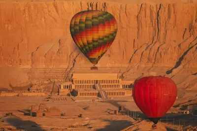 two hot air balloons flying over the acropolis at Sun wing guest house in Luxor