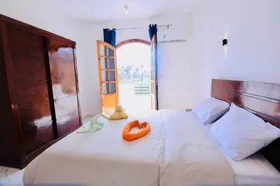 a bedroom with a bed with a orange bowl on it at Sun wing guest house in Luxor