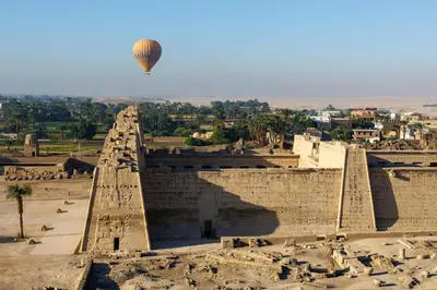 a hot air balloon flying over the ancientramids at Sun wing guest house in Luxor