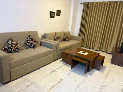 a living room with two couches and a coffee table at Cozy Seaside 1BR Apartment B4 in Turtles Beach - Hurghada in Hurghada