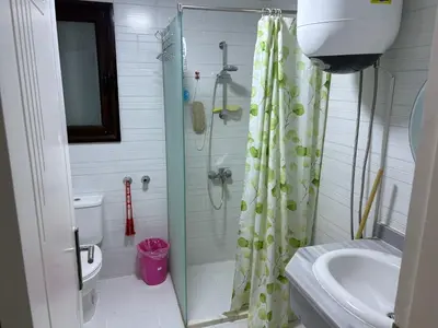 a bathroom with a shower and a toilet and a sink at Cozy Seaside 1BR Apartment B4 in Turtles Beach - Hurghada in Hurghada