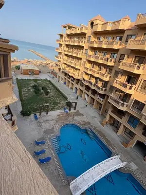 an aerial view of an apartment complex with a swimming pool at Cozy Seaside 1BR Apartment B4 in Turtles Beach - Hurghada in Hurghada