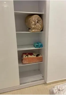 a white closet with some knick knacks in it at Florenza Khamsin Compound Deluxe Apartment C103 in Hurghada