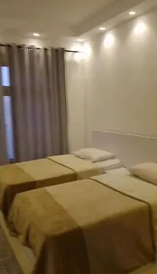 a room with two beds and a window at Florenza Khamsin Compound Deluxe Apartment C103 in Hurghada