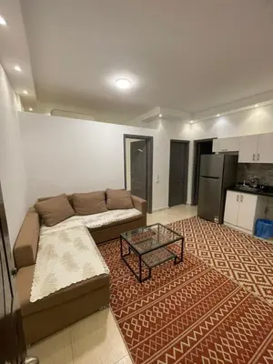 a living room with a couch and a coffee table at Florenza Khamsin Compound Deluxe Apartment C103 in Hurghada