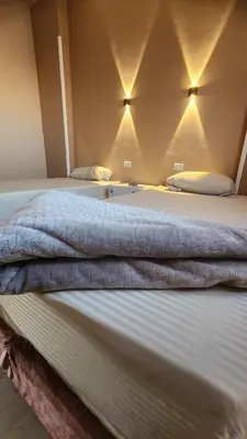 a large white bed in a room with lights at Shapon Hotel - Hurghada in Hurghada