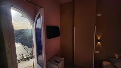 a room with a window with a view of a city at Shapon Hotel - Hurghada in Hurghada