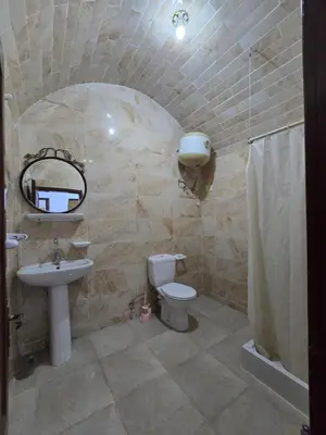 a bathroom with a sink toilet and a mirror at Gomla Flats in Hurghada