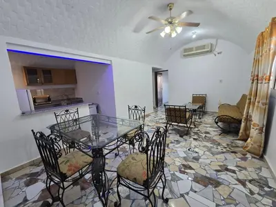a dining room with a glass table and chairs at Gomla Flats in Hurghada
