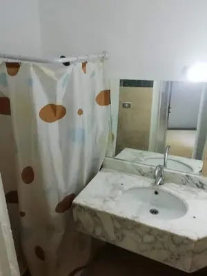 a bathroom with a sink and a shower curtain at Gomla Flats in Hurghada