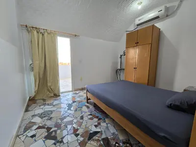 a bedroom with a bed and a window at Gomla Flats in Hurghada