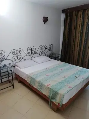 a bed sitting in a room with at Gomla Flats in Hurghada