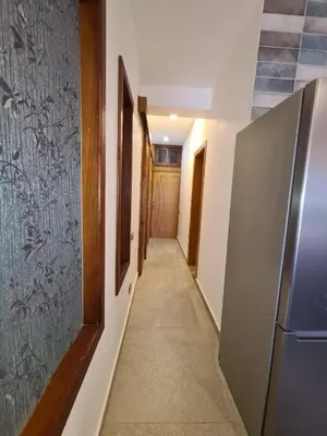 a hallway with a refrigerator and a hallway with a door at ElGouna west golf 2 bedrooms 2 bathrooms - pool in Hurghada
