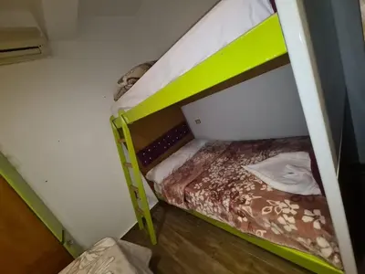 a bunk bed with a green bunk bed in a room at ElGouna west golf 2 bedrooms 2 bathrooms - pool in Hurghada