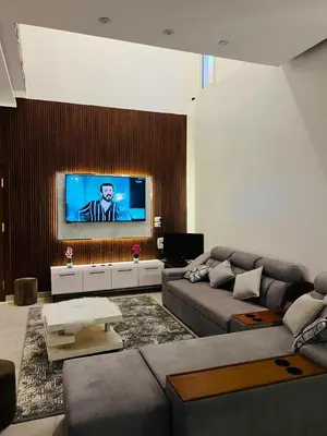 a living room with a couch and a flat screen tv at Twins Villa Luxor in Luxor