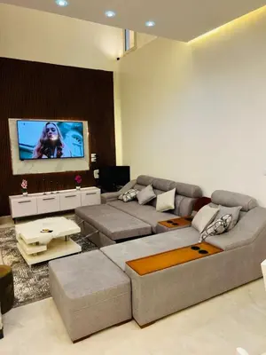 a living room with a couch and a flat screen tv at Twins Villa Luxor in Luxor