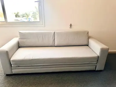 a white couch sitting in the corner of a room at Azure horizon,Karma Aqua beach resort,Hurghada in Hurghada
