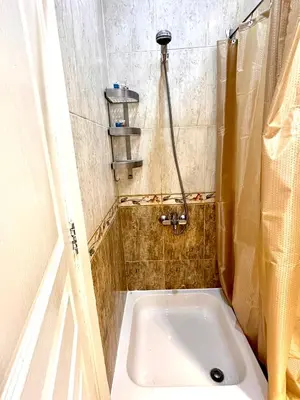 a small bathroom with a shower and a tub at Azure horizon,Karma Aqua beach resort,Hurghada in Hurghada