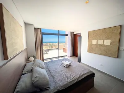 a bedroom with a bed and a large window at Stunning Penthouse Seaview Apt in Mesca, Somabay in Hurghada