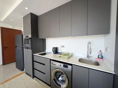 a kitchen with a sink and a washing machine at Stunning Penthouse Seaview Apt in Mesca, Somabay in Hurghada