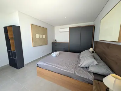 a bedroom with a large bed with a wooden headboard at Stunning Penthouse Seaview Apt in Mesca, Somabay in Hurghada