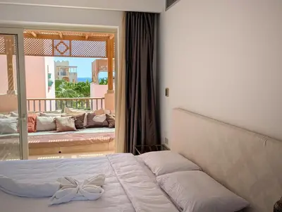 a bedroom with a bed with a bow on it at Light & Airy Spacious Soma bay Marina 3BR w Sauna & Hot tub in Hurghada