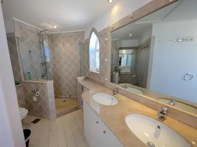a bathroom with two sinks and a large mirror at Light & Airy Spacious Soma bay Marina 3BR w Sauna & Hot tub in Hurghada