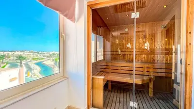 a bath room with a bench and a window at Light & Airy Spacious Soma bay Marina 3BR w Sauna & Hot tub in Hurghada