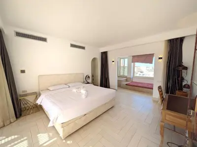 a bedroom with a large white bed in a room at Light & Airy Spacious Soma bay Marina 3BR w Sauna & Hot tub in Hurghada
