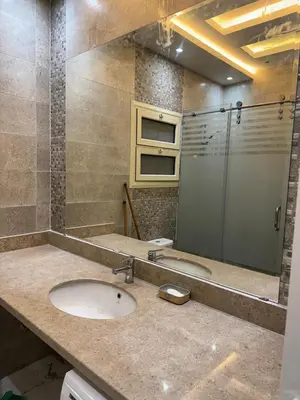 a bathroom with a sink and a glass shower at 1st Time Rental, 2 BDR Apartment, Pool View, Intercontinental District in Hurghada