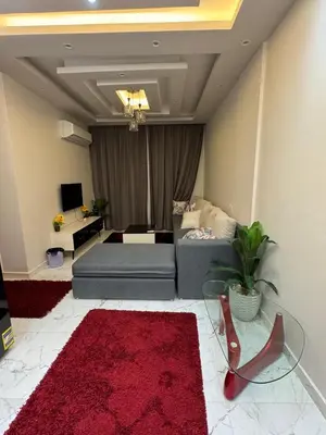 a living room with a couch and a red rug at 1st Time Rental, 2 BDR Apartment, Pool View, Intercontinental District in Hurghada